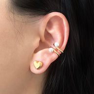 Lady wearing Angie Heart Stud Earrings by Deduet with Mina ear cuff by Deduet