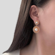 Lady wearing Chrissy Pearl Drop Earrings in Gold by Deduet