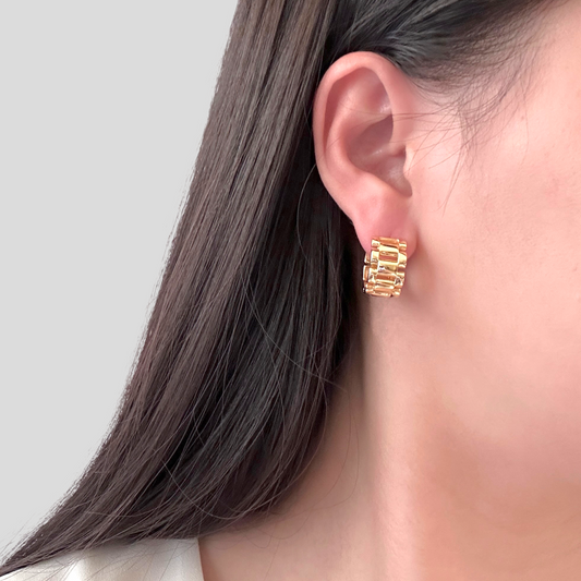 Lady wearing Phoenix Watch Band Hoop Earrings in Gold Color by Deduet